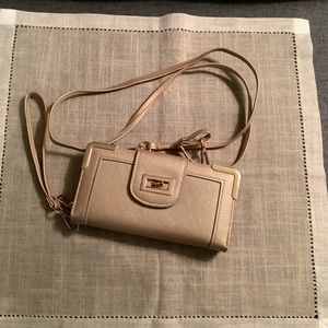 Crossbody or wristlet  soft gold color with gold trim.  Never used.